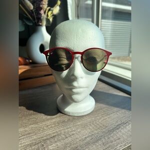 Gucci 52 mm round red framed sunglasses with red mirrored lenses.